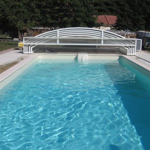 a swimming pool with a white bench